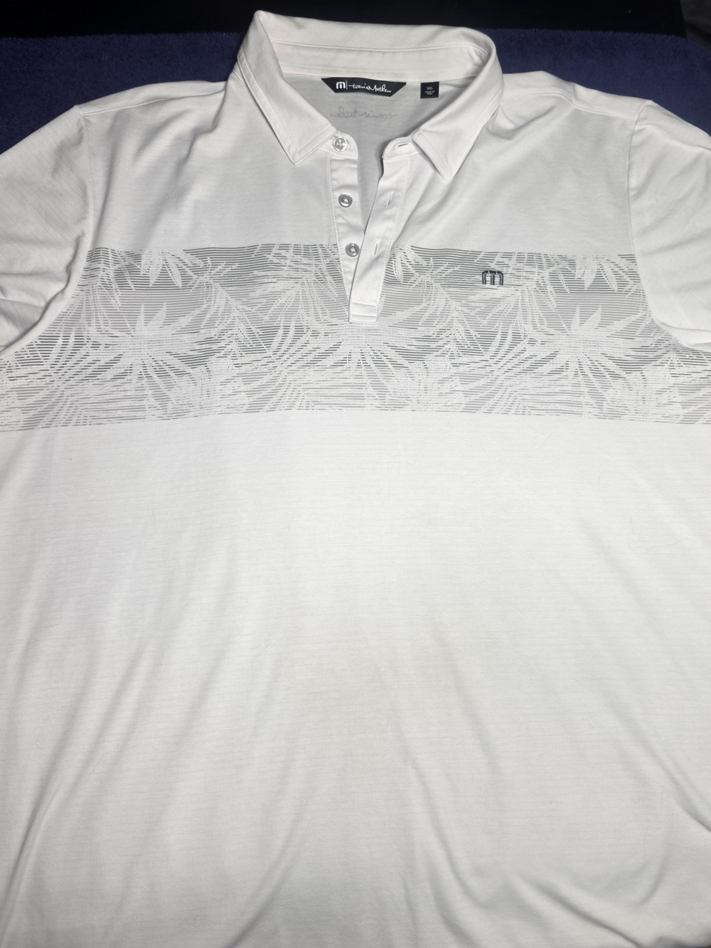 TravisMathew White Polo with Subtle Leaf Stripe